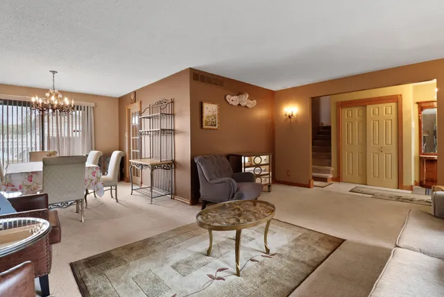 a large kitchen with stainless steel appliances a large counter top a stove and a refrigerator