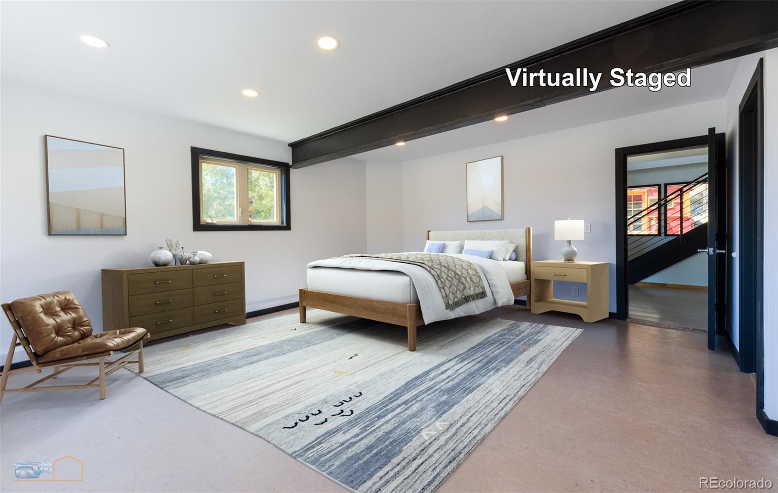 548 Coughlin Meadows Road Boulder, CO 80302 - Photo 17 of 49 a spacious bedroom with a bed a couch and a large window