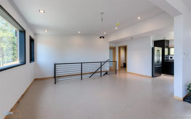 an empty room with windows and a projector