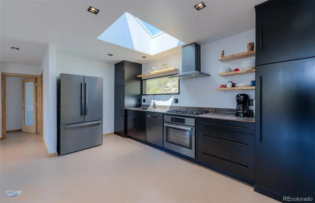 a kitchen with granite countertop stainless steel appliances and wooden cabinets