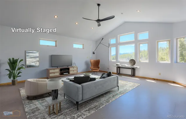 a living room with furniture a large window and a flat screen tv