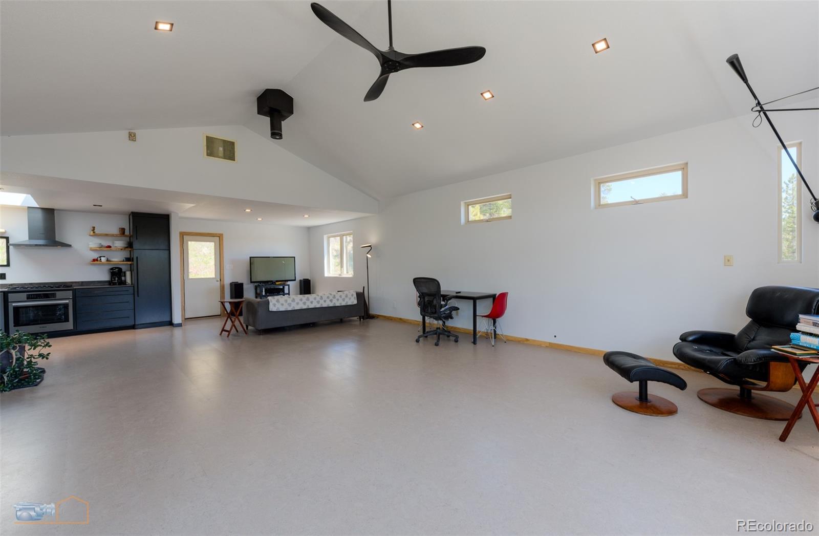 548 Coughlin Meadows Road Boulder, CO 80302 - Photo 26 of 49 a living room with furniture and a flat screen tv