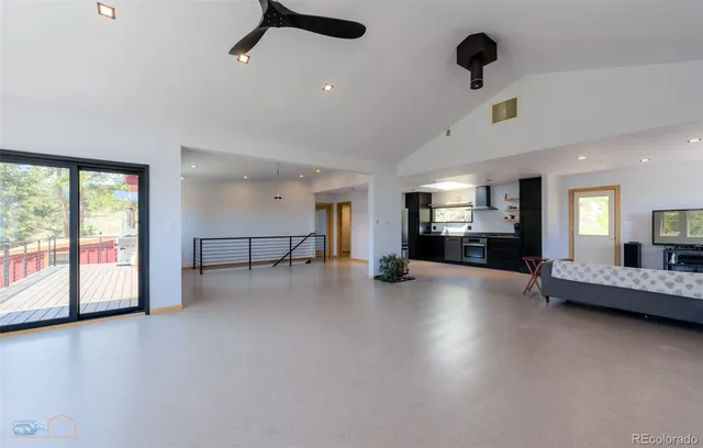 a view of a livingroom with furniture hardwood floor and a ceiling fan