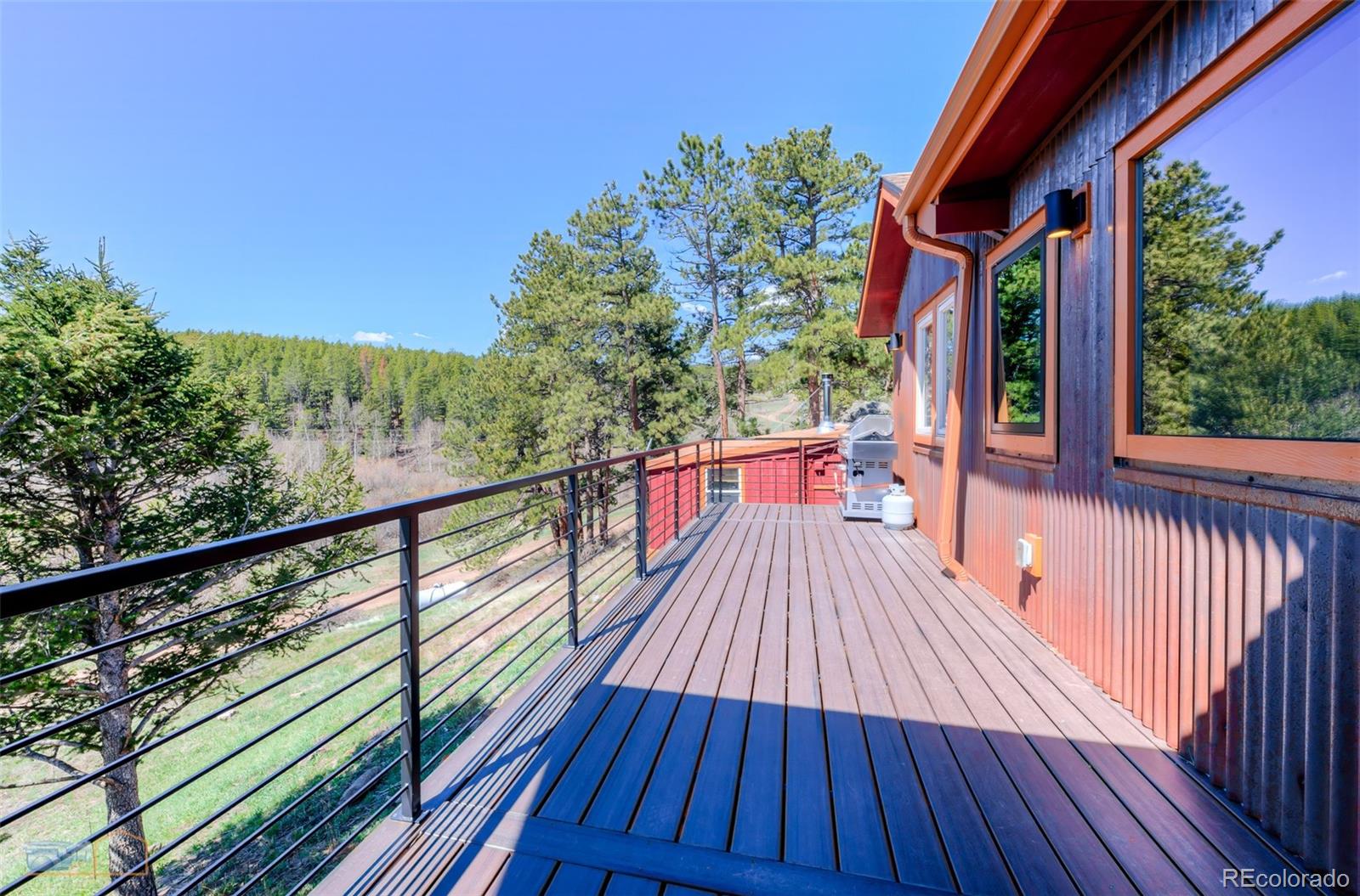548 Coughlin Meadows Road Boulder, CO 80302 - Photo 28 of 50 a view of balcony with wooden floor and outdoor space