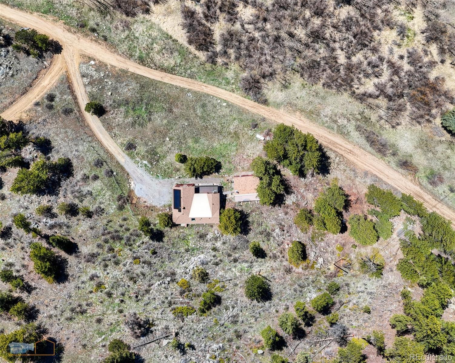 548 Coughlin Meadows Road Boulder, CO 80302 - Photo 29 of 49 a view of a yard with plants and wooden fence