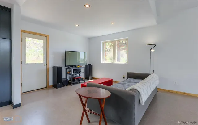 a bedroom with a bed a table and chair