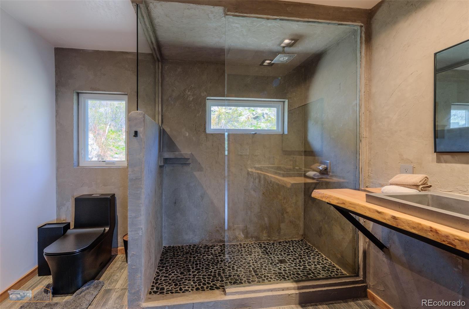 548 Coughlin Meadows Road Boulder, CO 80302 - Photo 39 of 50 a bathroom with a sink a toilet and mirror