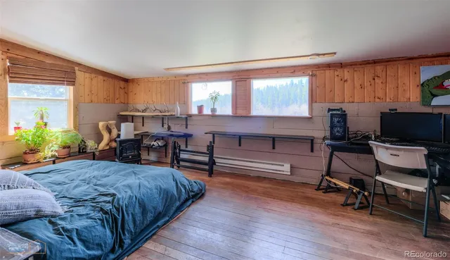 a view of a workspace with furniture and wooden floor