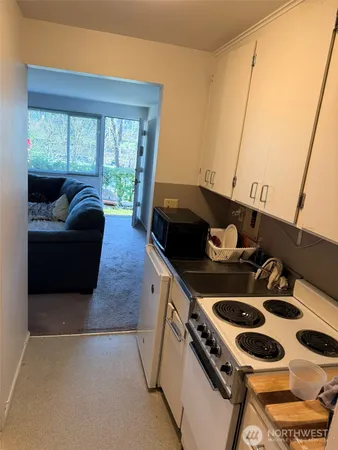 a kitchen with a stove and a white refrigerator