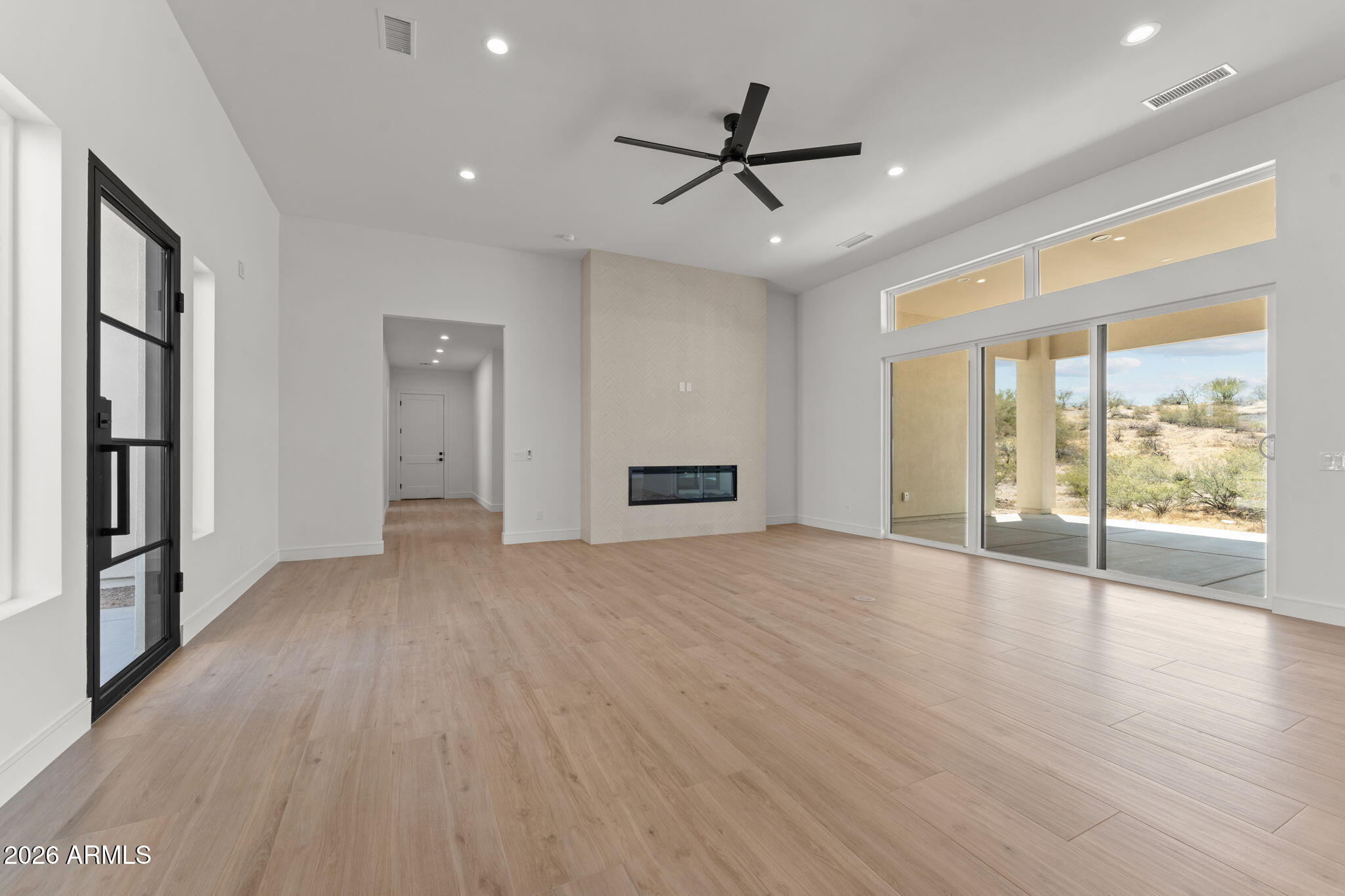 2855 Percheron Road Wickenburg, AZ 85390 - Photo 13 of 58 a view of an empty room with a window and wooden floor