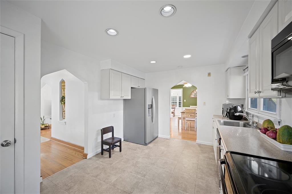 991 Forsythe Road Carnegie, PA 15106 - Photo 13 of 49 a living room with furniture a flat screen tv and a refrigerator