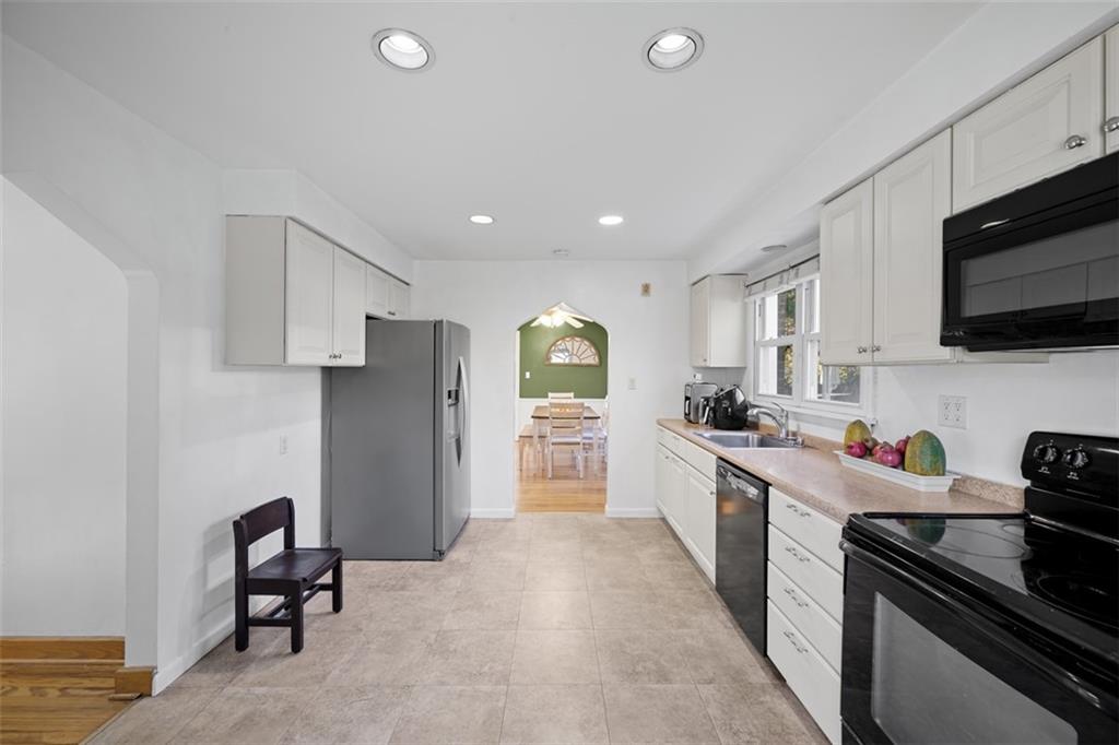 991 Forsythe Road Carnegie, PA 15106 - Photo 14 of 49 a kitchen with stainless steel appliances kitchen island granite countertop a refrigerator and a stove top oven