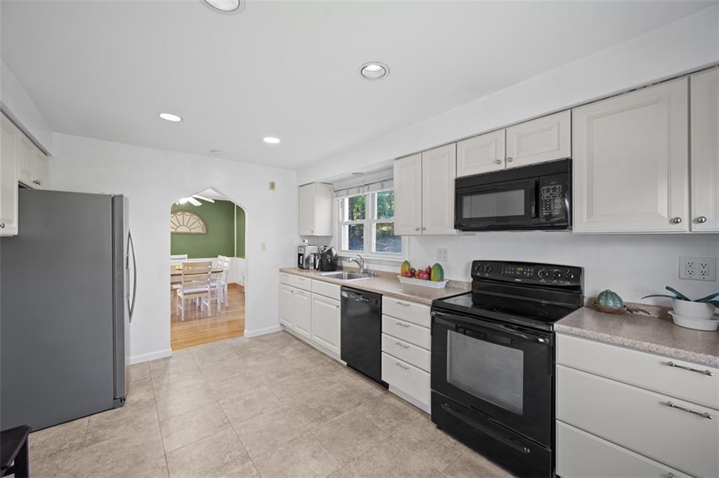 991 Forsythe Road Carnegie, PA 15106 - Photo 15 of 49 a kitchen with a sink stove and microwave