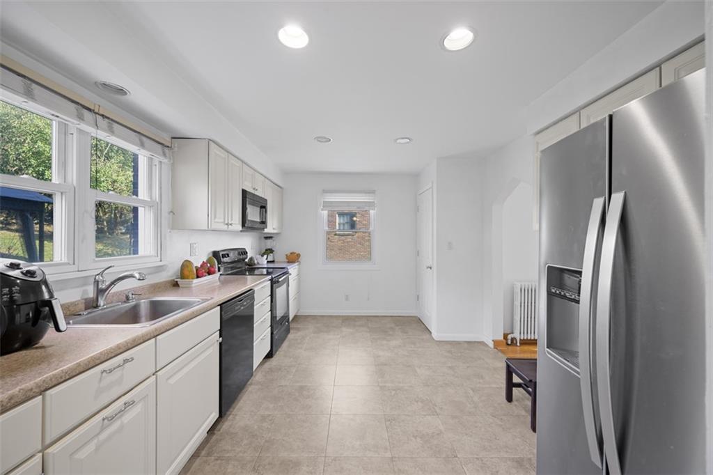 991 Forsythe Road Carnegie, PA 15106 - Photo 16 of 49 a kitchen that has a lot of cabinets a sink and appliances in it
