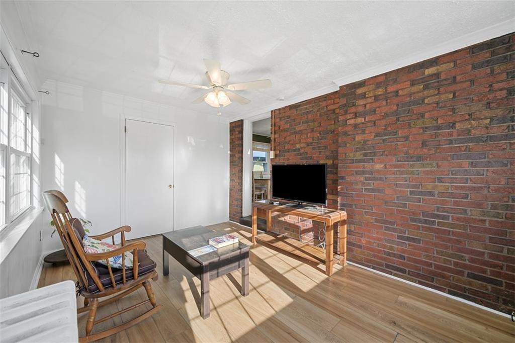 991 Forsythe Road Carnegie, PA 15106 - Photo 17 of 49 a living room with a flat screen tv and a fireplace