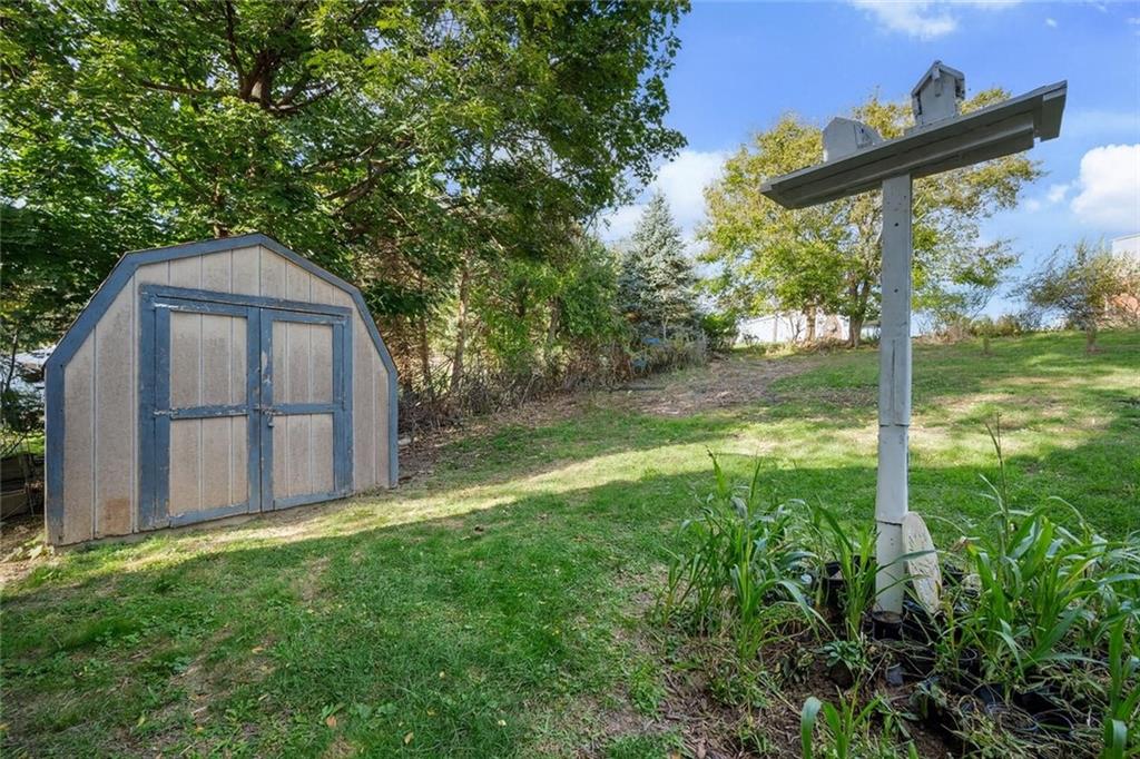 991 Forsythe Road Carnegie, PA 15106 - Photo 41 of 49 a backyard of a house with large trees and wooden fence