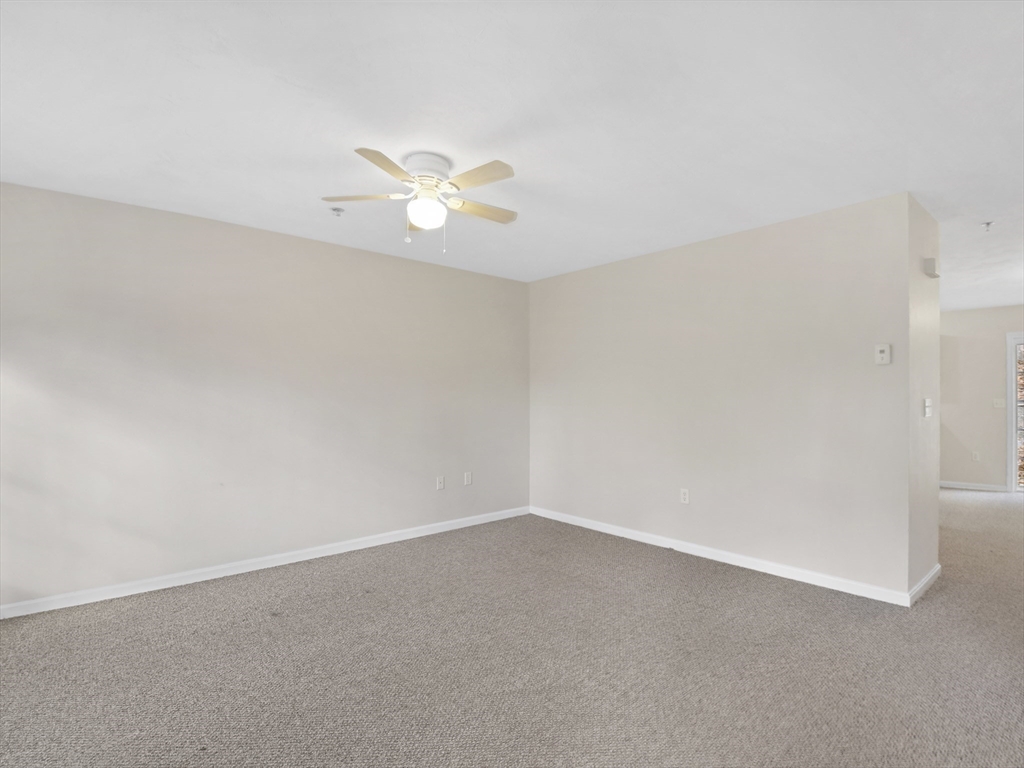 350 Riverbend Street, Unit 108 Athol, MA 01331 - Photo 11 of 27 an empty room with a empty space and a ceiling fan