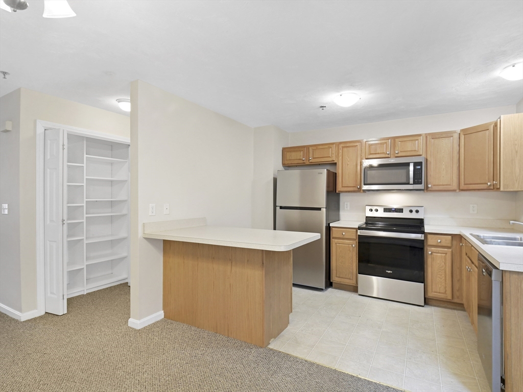 350 Riverbend Street, Unit 108 Athol, MA 01331 - Photo 8 of 27 a kitchen with cabinets and stainless steel appliances