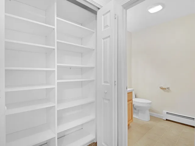 a bathroom with a toilet and a view of bathroom