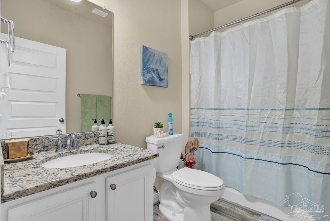 5364 Red Shoulder Road Pace, FL 32571 - Photo 13 of 46 a bathroom with a granite countertop sink toilet and shower