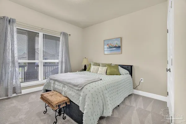 a spacious bedroom with a bed and furniture