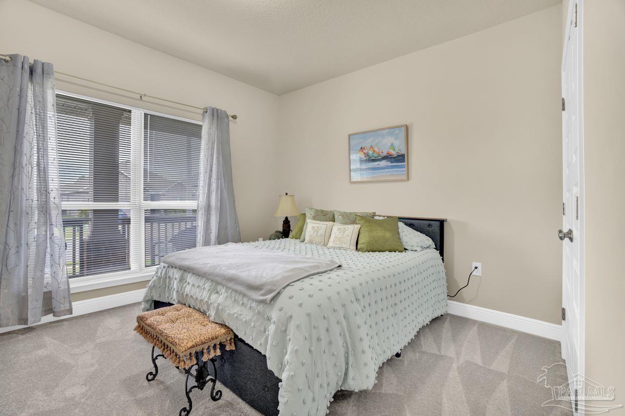 5364 Red Shoulder Road Pace, FL 32571 - Photo 15 of 46 a bedroom with a bed and a large window