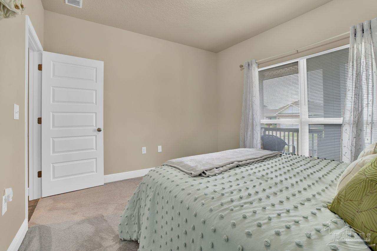 5364 Red Shoulder Road Pace, FL 32571 - Photo 16 of 46 a bedroom with a bed and a window