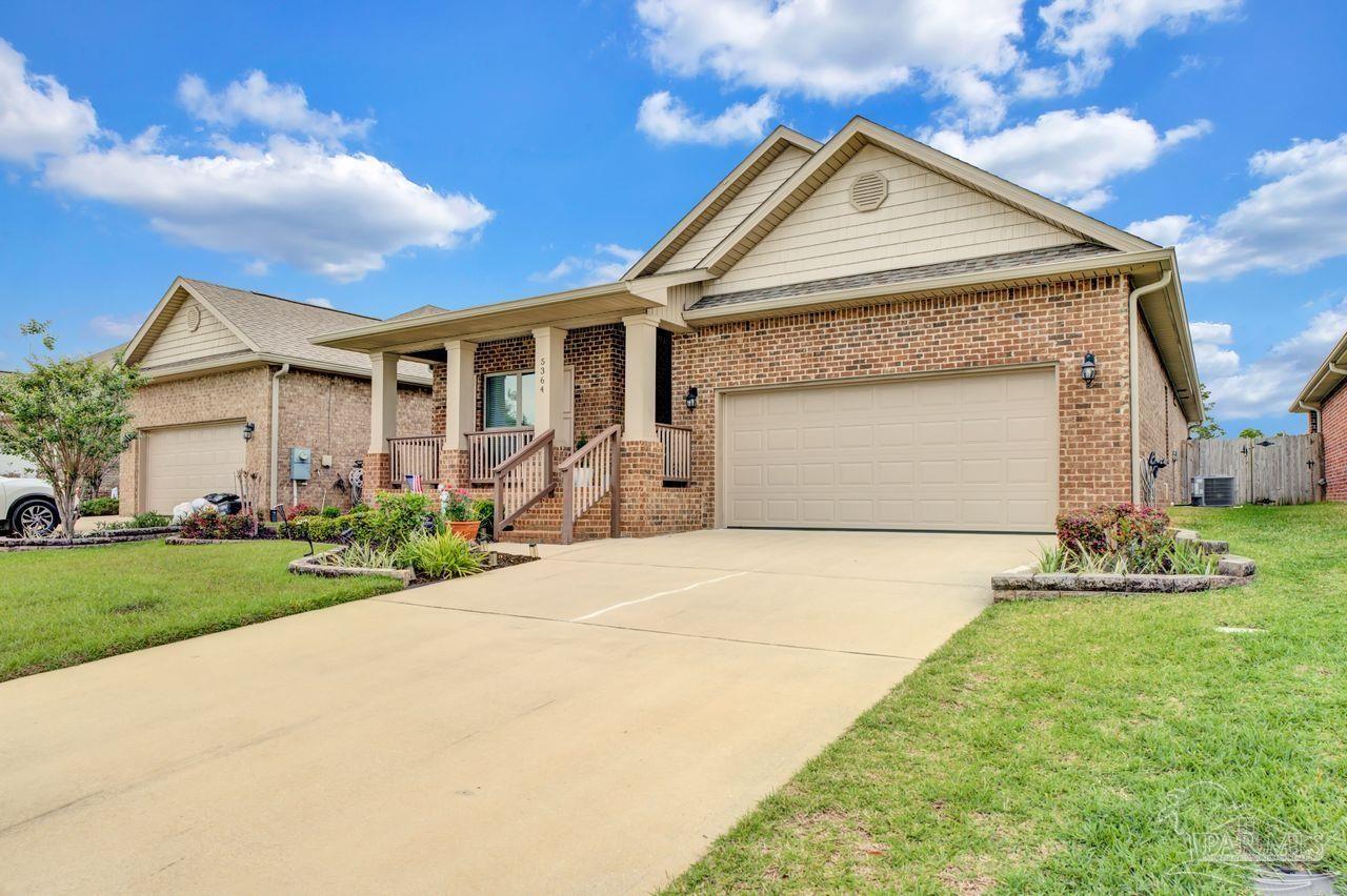 5364 Red Shoulder Road Pace, FL 32571 - Photo 2 of 46 a front view of a house with garden