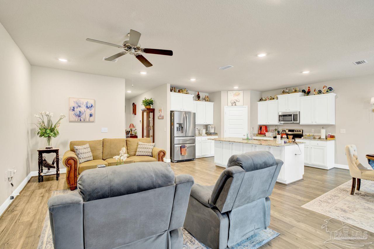 5364 Red Shoulder Road Pace, FL 32571 - Photo 25 of 46 a living room with furniture and kitchen view