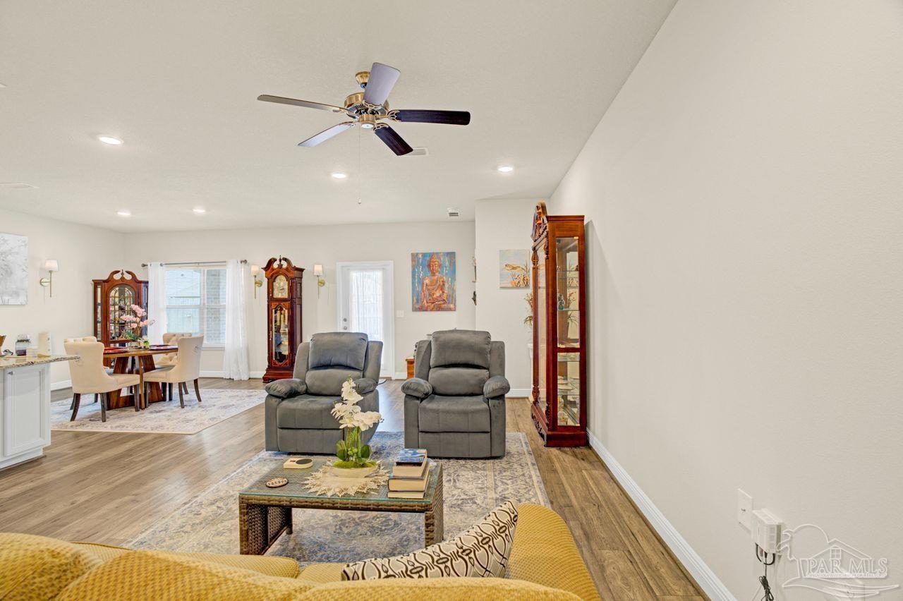 5364 Red Shoulder Road Pace, FL 32571 - Photo 26 of 46 a living room with furniture and a wooden floor