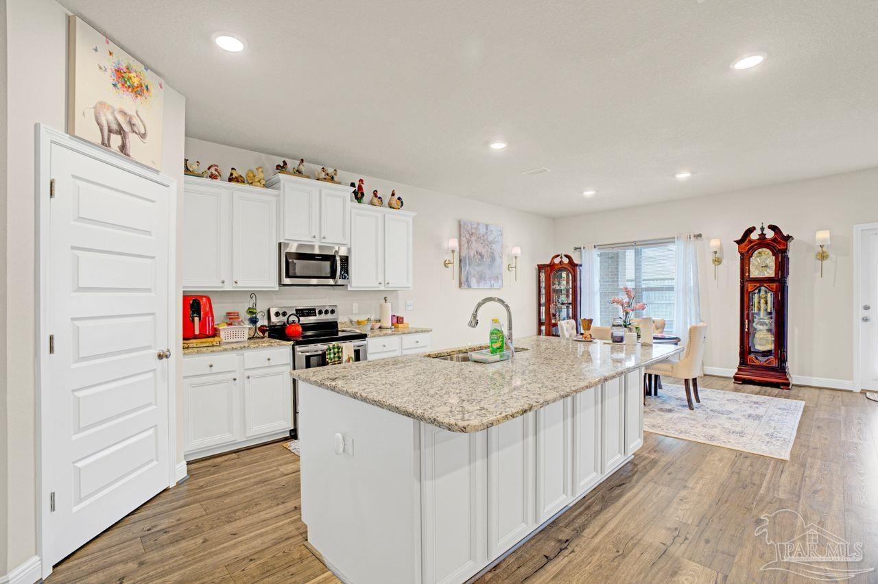 5364 Red Shoulder Road Pace, FL 32571 - Photo 27 of 46 a view of kitchen with cabinets and wooden floor