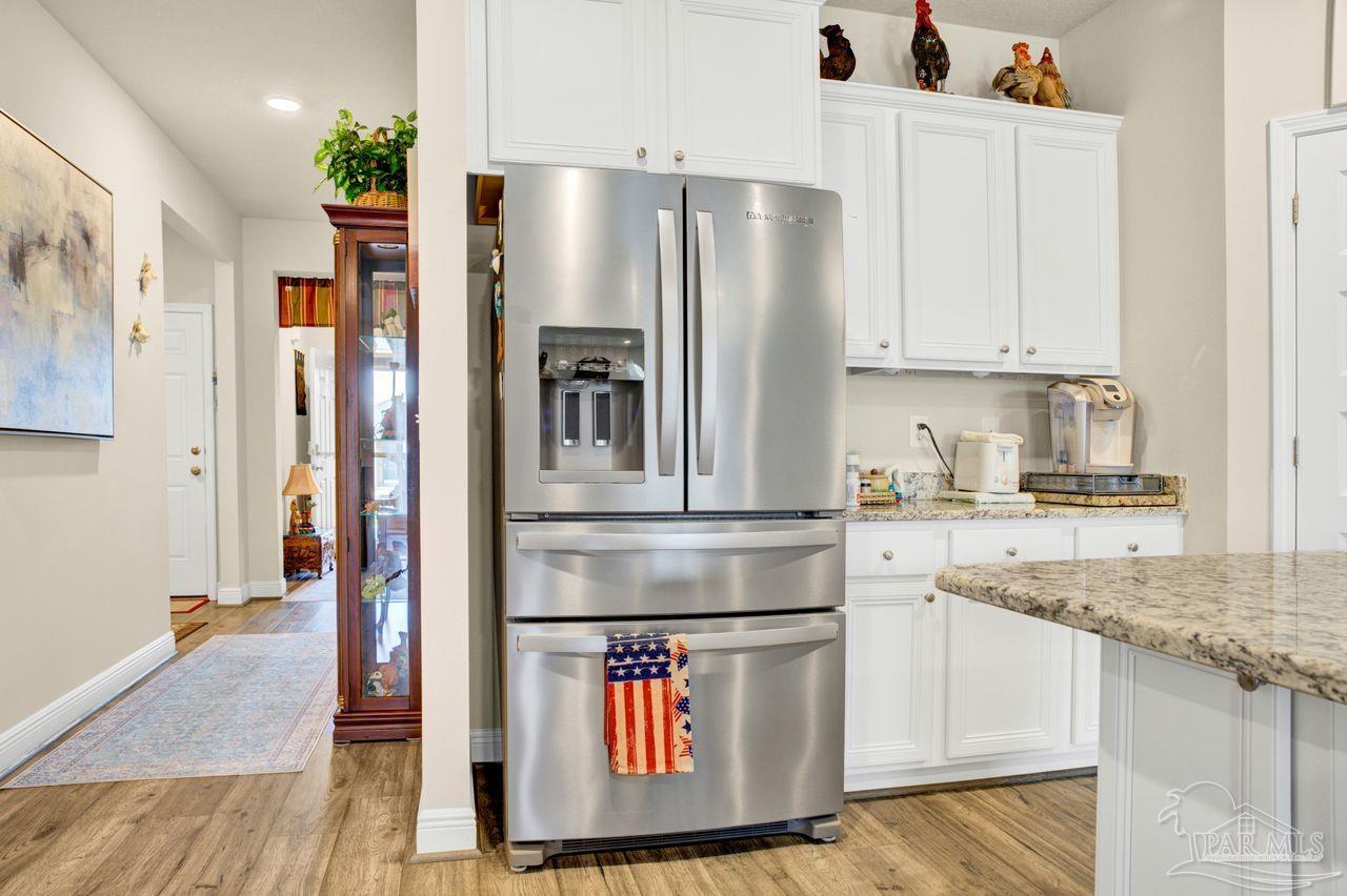 5364 Red Shoulder Road Pace, FL 32571 - Photo 28 of 46 a kitchen with stainless steel appliances granite countertop a refrigerator a stove and a sink