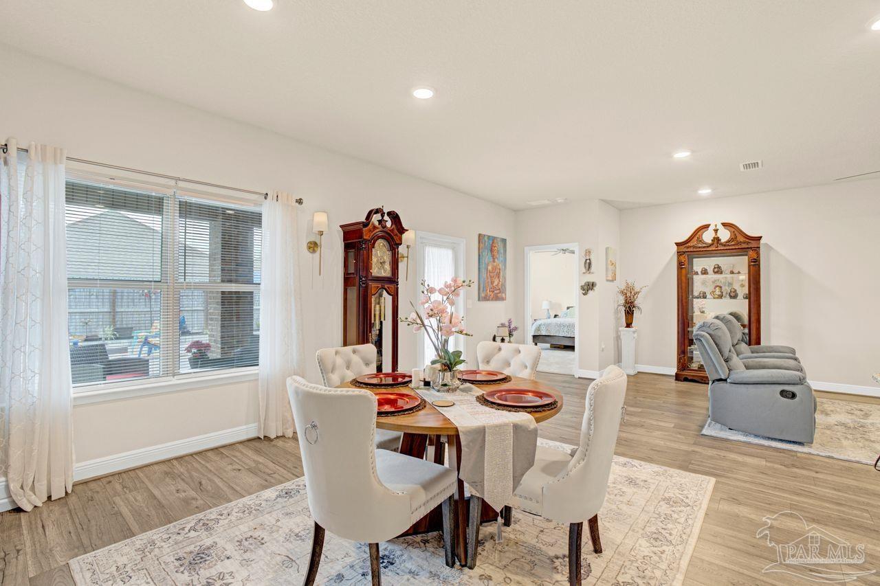 5364 Red Shoulder Road Pace, FL 32571 - Photo 31 of 46 a view of a dining room with furniture and a window