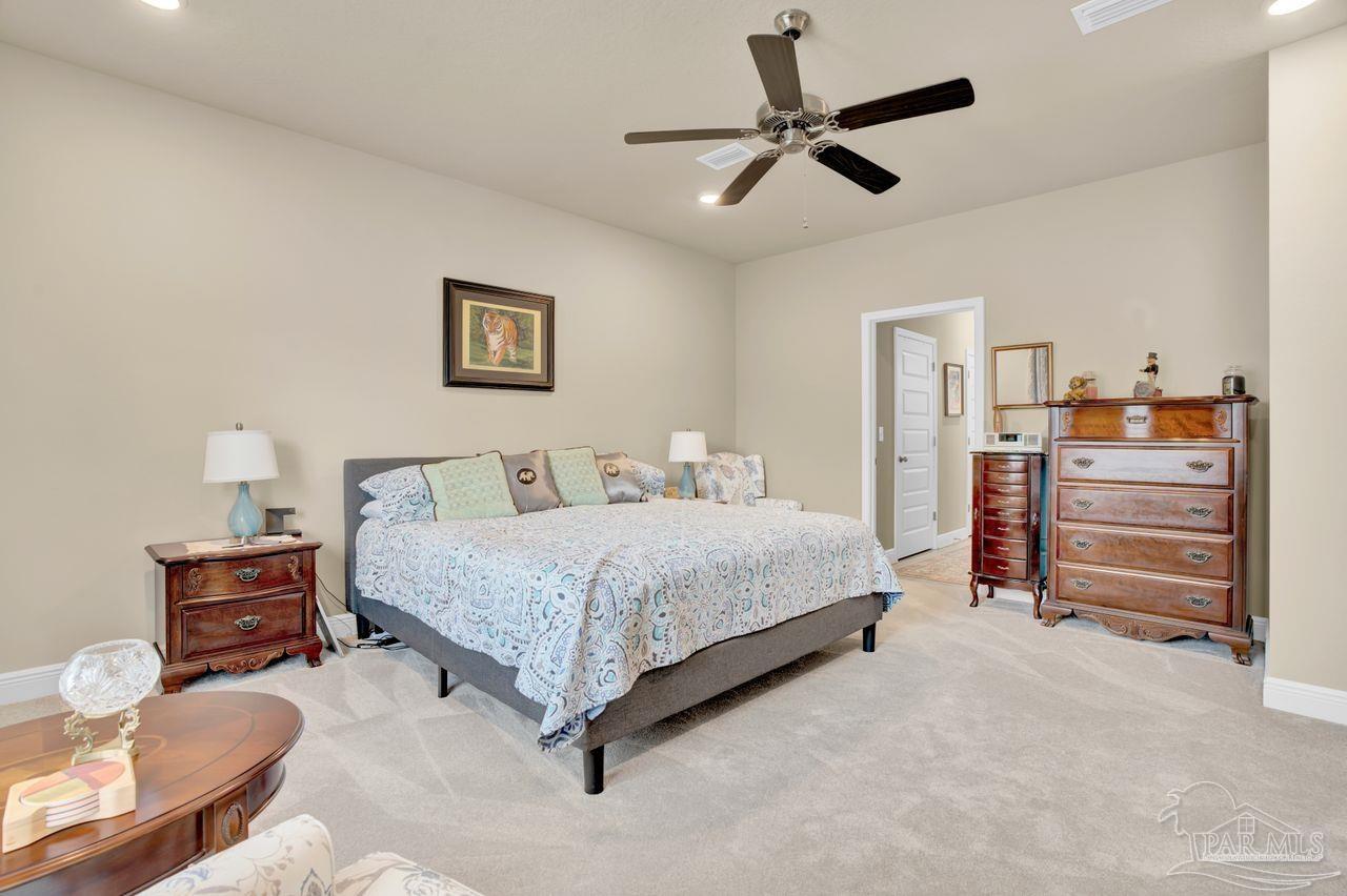 5364 Red Shoulder Road Pace, FL 32571 - Photo 35 of 46 a spacious bedroom with a bed and furniture