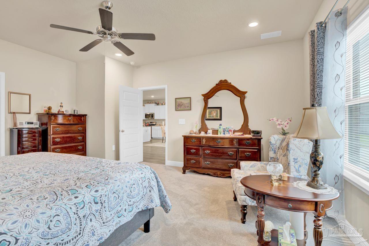 5364 Red Shoulder Road Pace, FL 32571 - Photo 36 of 46 a bedroom with a bed and a chandelier