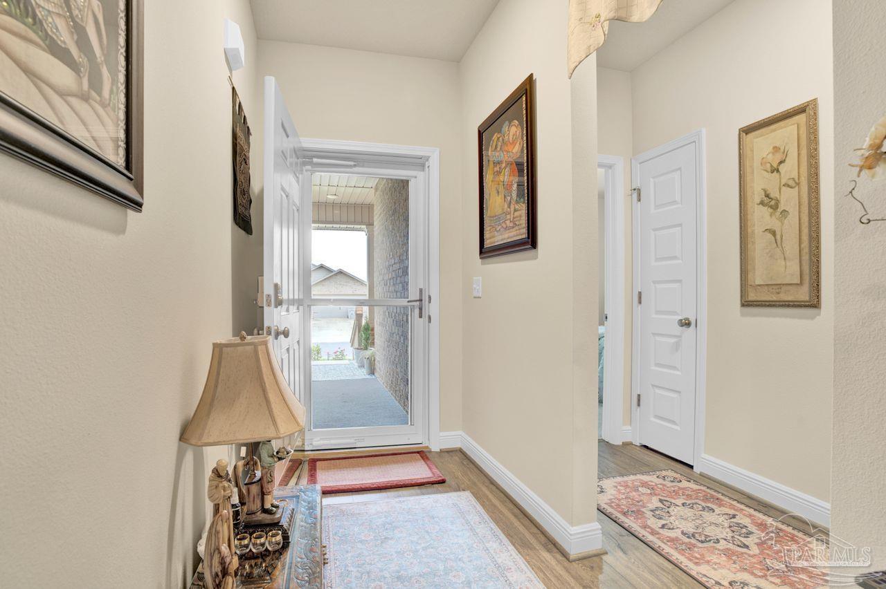 5364 Red Shoulder Road Pace, FL 32571 - Photo 10 of 46 a view of an entryway with wooden floor