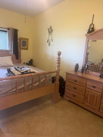 a bedroom with a bed and a mirror