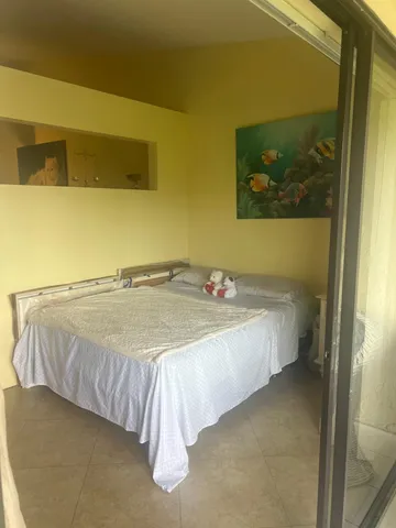 a bed sitting in a bedroom next to a bathroom