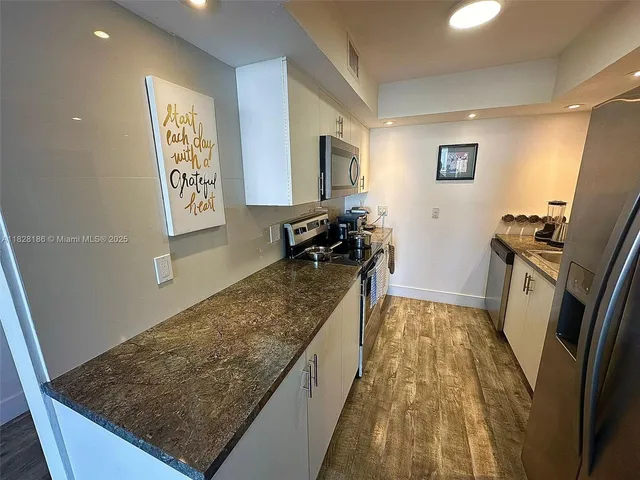 a living room with rug floor and a rug