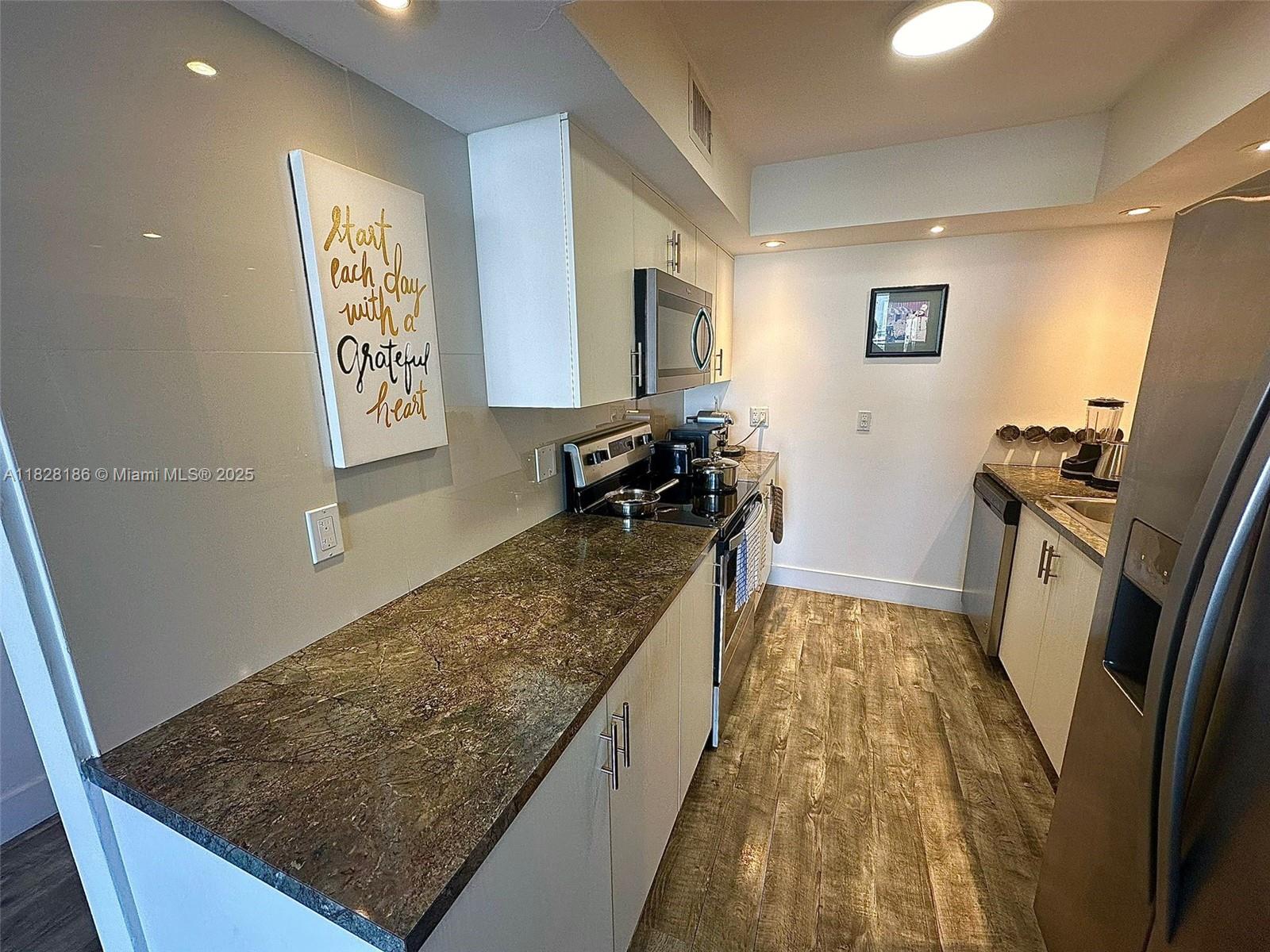 13499 Biscayne Boulevard, Unit 1013 North Miami, FL 33181 - Photo 14 of 25 a living room with rug floor and a rug