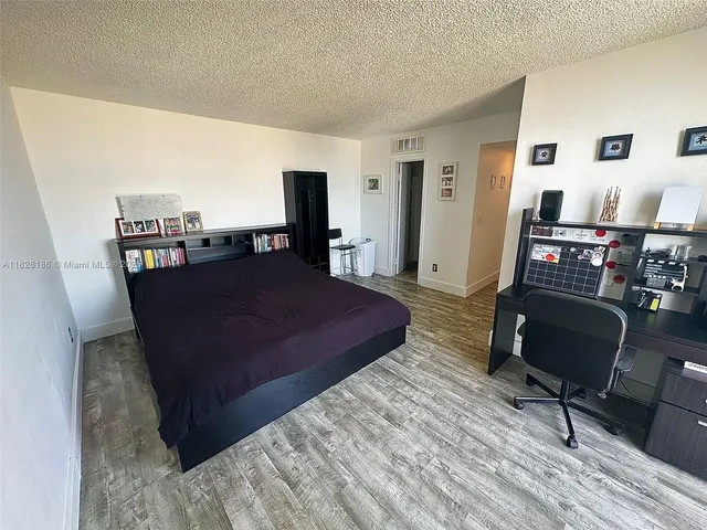 a bed room with a bed and a chair