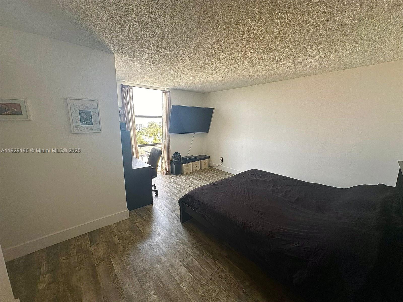13499 Biscayne Boulevard, Unit 1013 North Miami, FL 33181 - Photo 18 of 25 a bedroom with a bed and a window