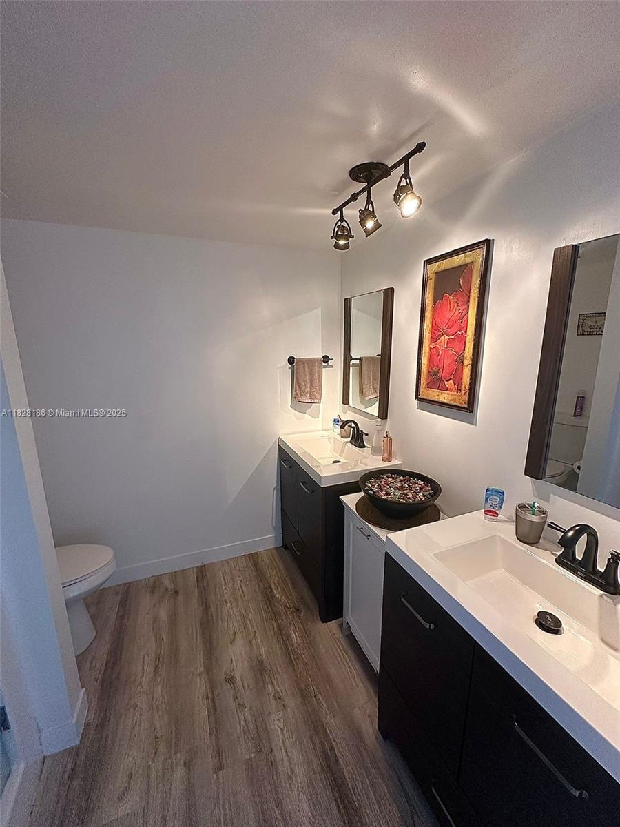 13499 Biscayne Boulevard, Unit 1013 North Miami, FL 33181 - Photo 23 of 25 a kitchen with a sink appliances and wooden floor