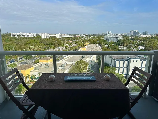 a view of a chairs and table in a balcony