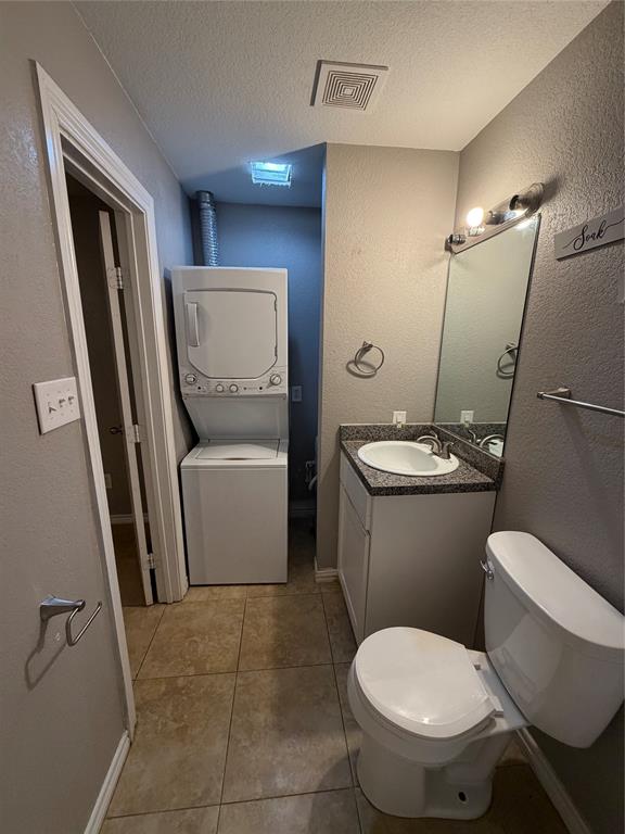 9805 Walnut Street, Unit C102 Dallas, TX 75243 - Photo 4 of 15 a white toilet sitting next to a bathroom sink and a mirror