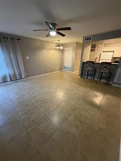 a view of a livingroom with furniture and a ceiling fan