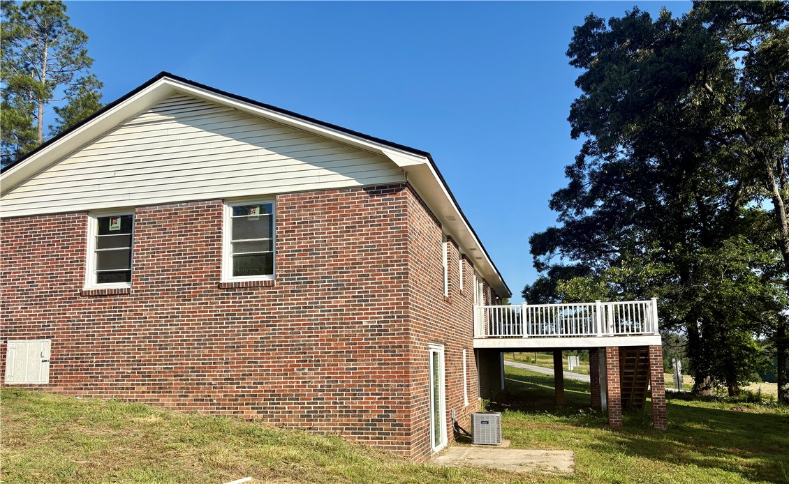 351 Randys Road Westminster, SC 29693 - Photo 6 of 30 A classic brick exterior with a well-maintained deck awaits, offering a charming outdoor space.