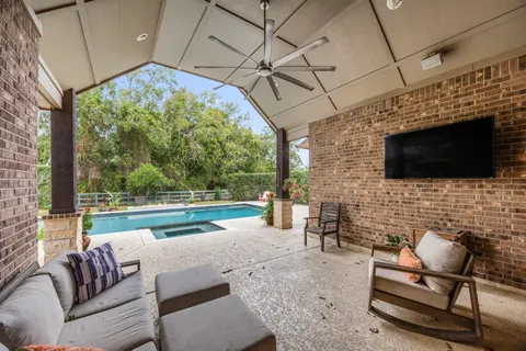 a living room with furniture fireplace and flat screen tv