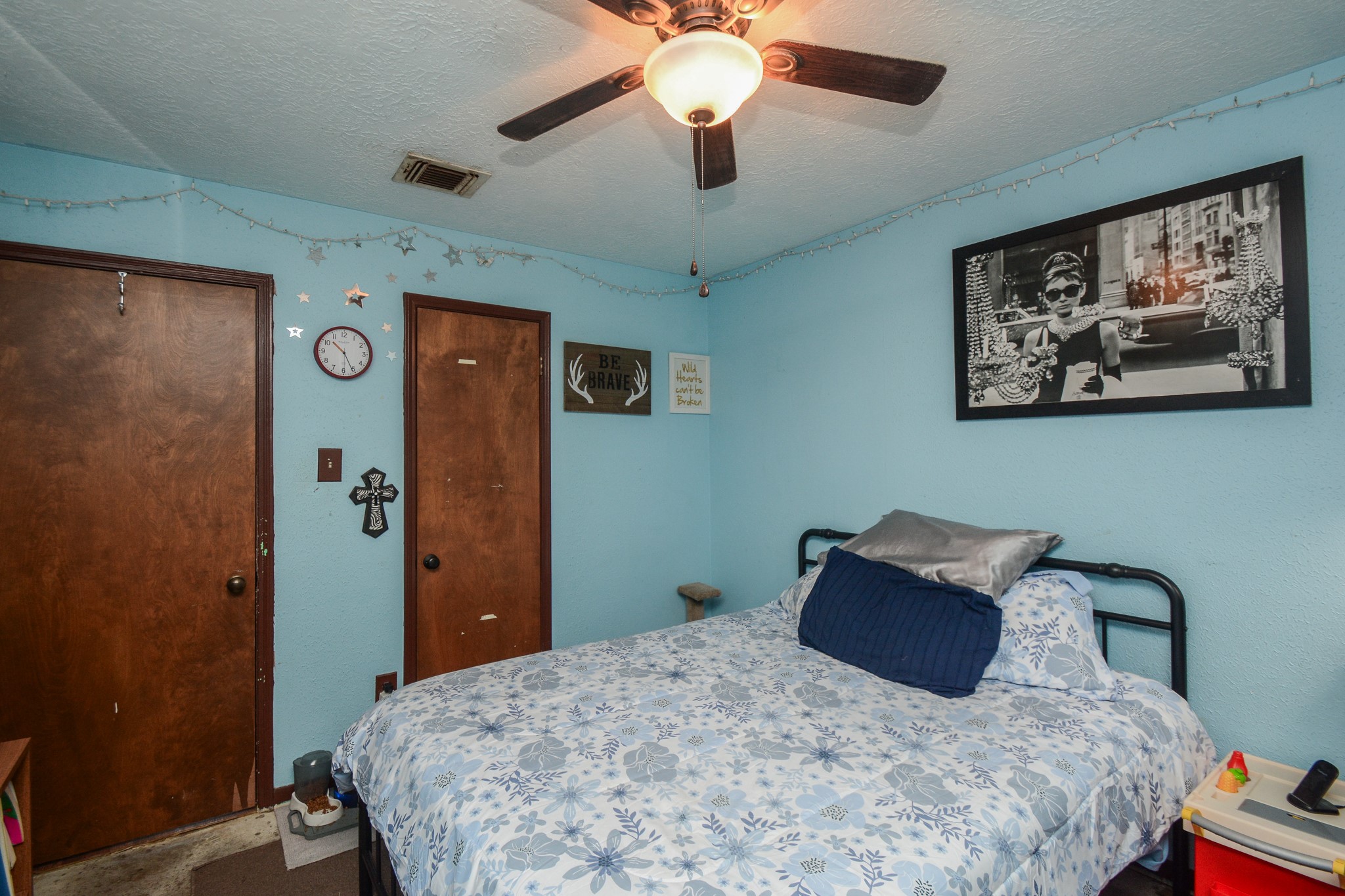 13630 Oleoke Lane Houston, TX 77015 - Photo 11 of 16 a bedroom with a bed and a chandelier