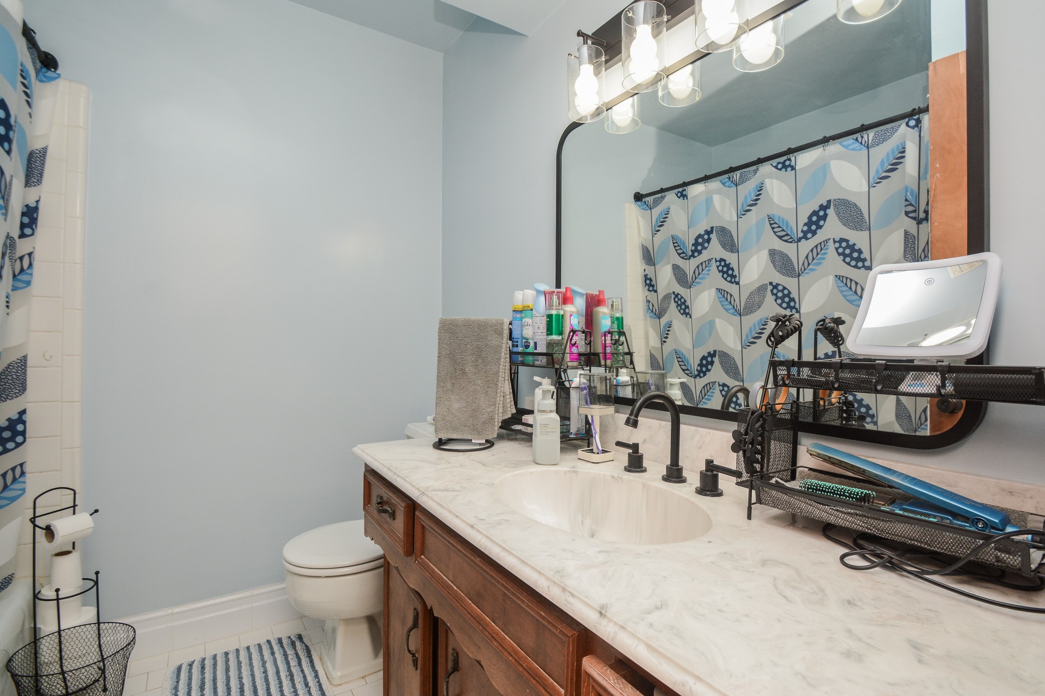 13630 Oleoke Lane Houston, TX 77015 - Photo 12 of 16 a bathroom with a granite countertop sink a toilet and a mirror